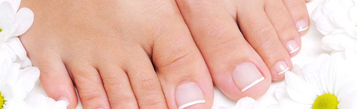 5962067 - flowers around beautiful female feet with the french pedicure